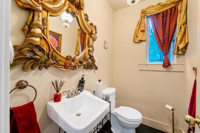 bathroom with tile patterned flooring, toilet, and sink