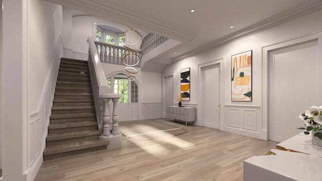 entryway featuring light hardwood / wood-style floors, plenty of natural light, and ornamental molding