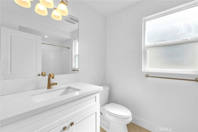 bathroom with walk in shower, vanity, toilet, and tile patterned flooring