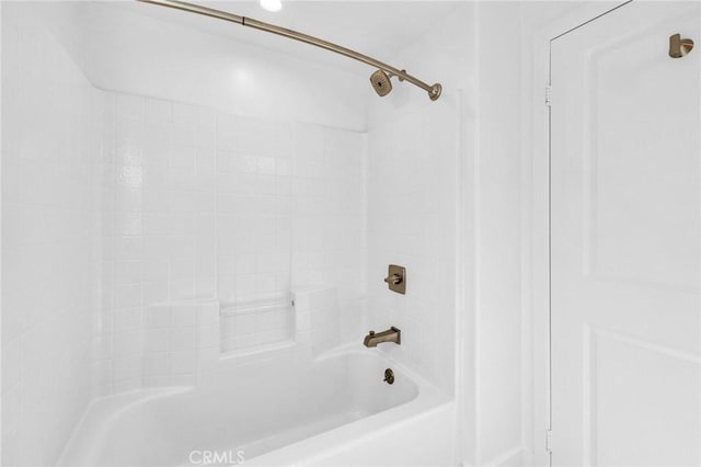 bathroom with bathing tub / shower combination