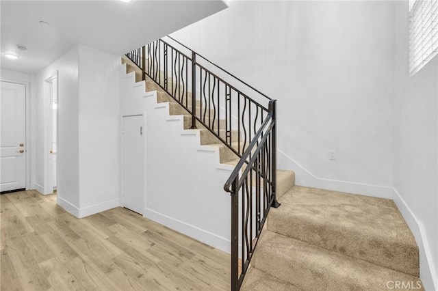 stairway featuring hardwood / wood-style floors