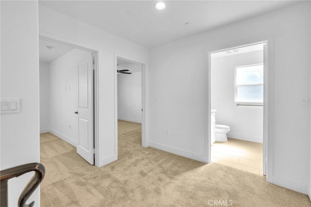 hallway with light colored carpet