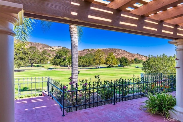 view of patio featuring a mountain view, a pergola, and fence