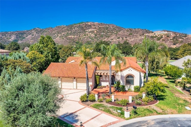 view of front of home featuring a mountain view and a garage