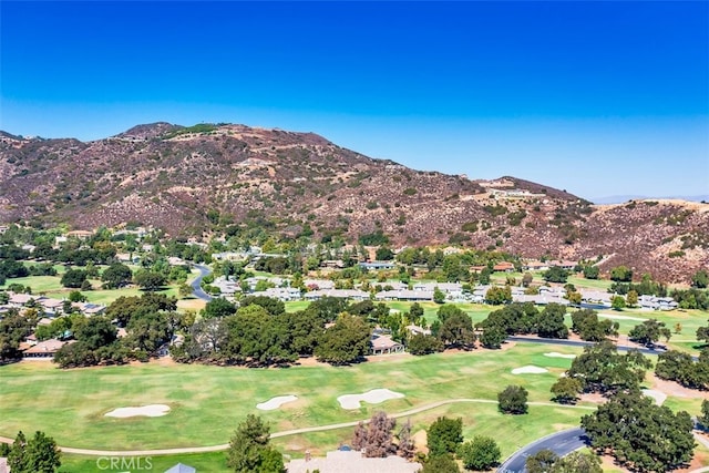 bird's eye view with a mountain view and view of golf course