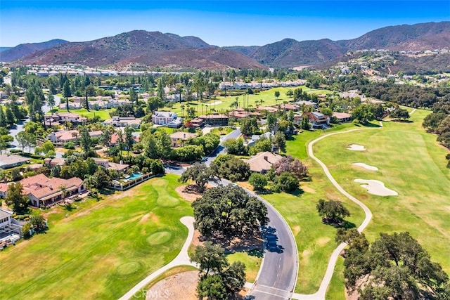 drone / aerial view with a mountain view and view of golf course