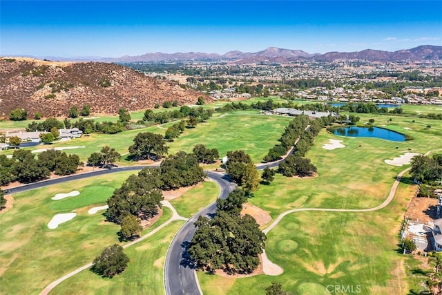 bird's eye view with golf course view and a water and mountain view