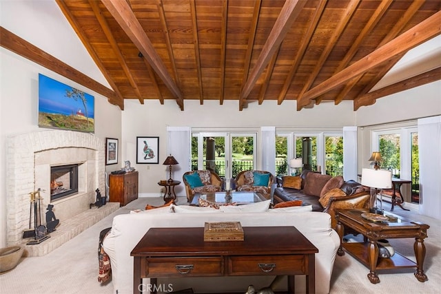 living area with wood ceiling, a fireplace, beamed ceiling, and carpet floors