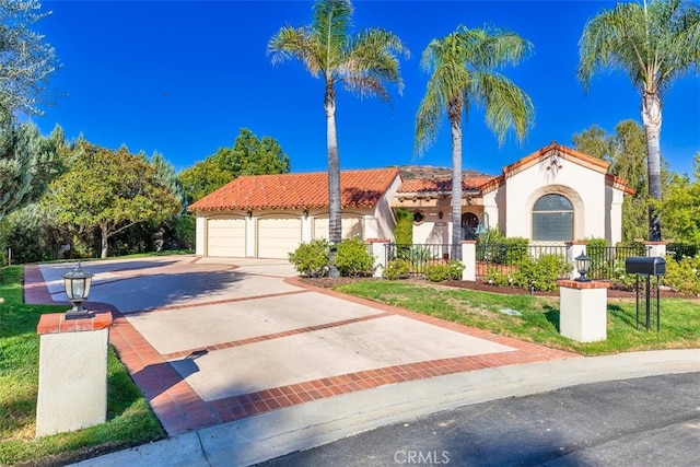 mediterranean / spanish-style house featuring a fenced front yard and a tile roof