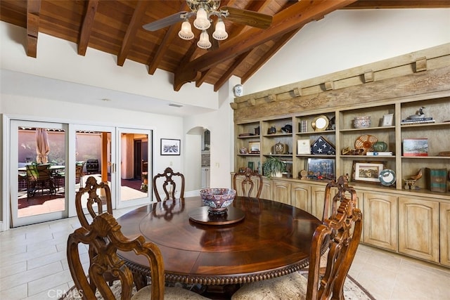 dining area with visible vents, beamed ceiling, wood ceiling, arched walkways, and a ceiling fan