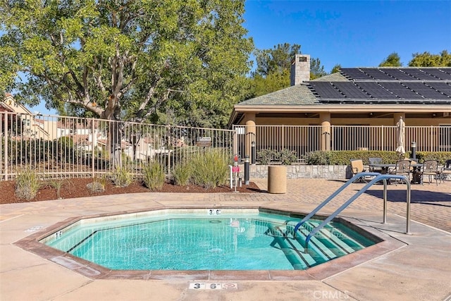 view of swimming pool featuring a patio area and fence