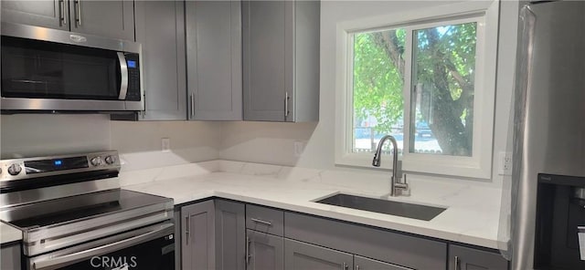 3590 Redwood St, Clearlake, CA 95422 - kitchen featuring appliances with stainless steel finishes, gray cabinets, and light stone counters