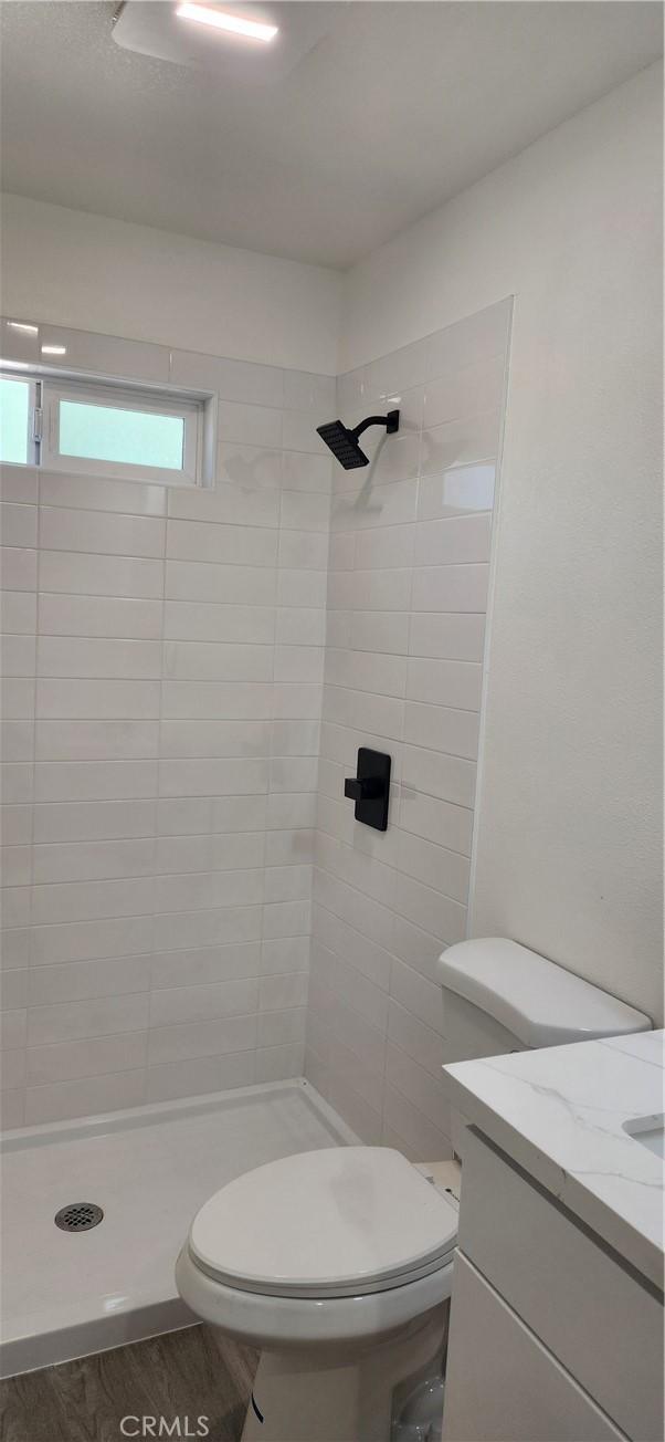 3590 Redwood St, Clearlake, CA 95422 - full bath featuring a stall shower, vanity, and wood finished floors
