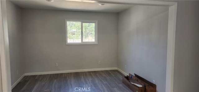 spare room featuring dark hardwood / wood-style floors