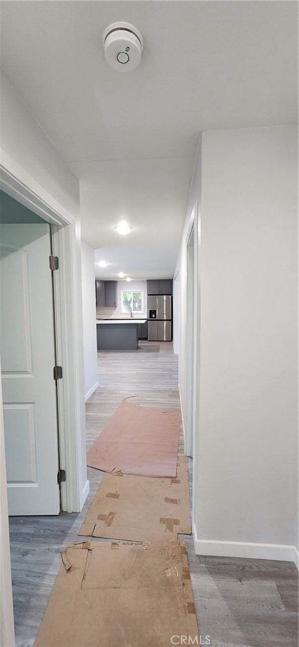 3590 Redwood St, Clearlake, CA 95422 - corridor featuring wood finished floors and baseboards