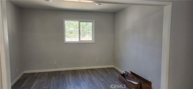 empty room featuring dark hardwood / wood-style flooring