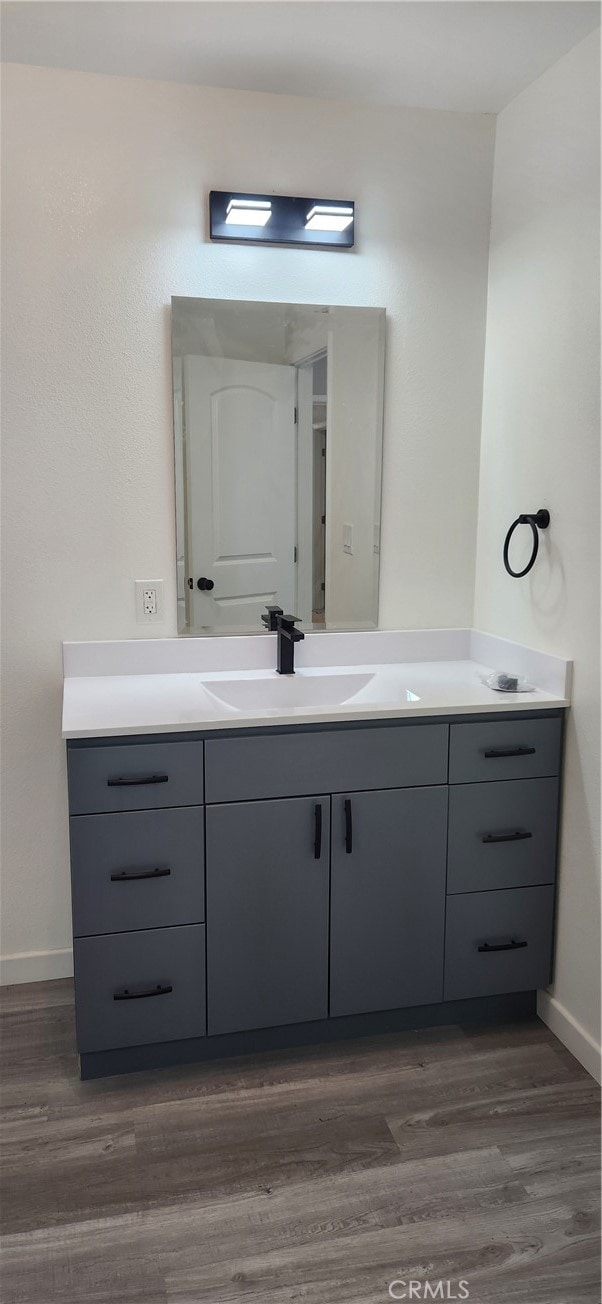 bathroom featuring vanity and hardwood / wood-style floors