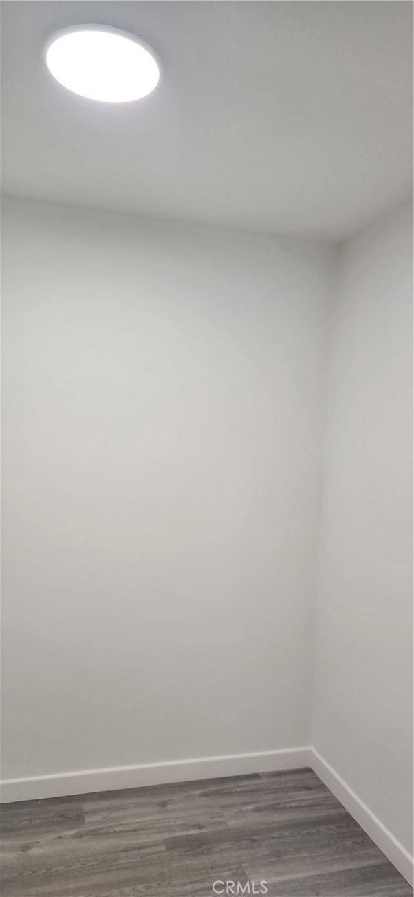 3590 Redwood St, Clearlake, CA 95422 - spare room with baseboards and dark wood-style flooring