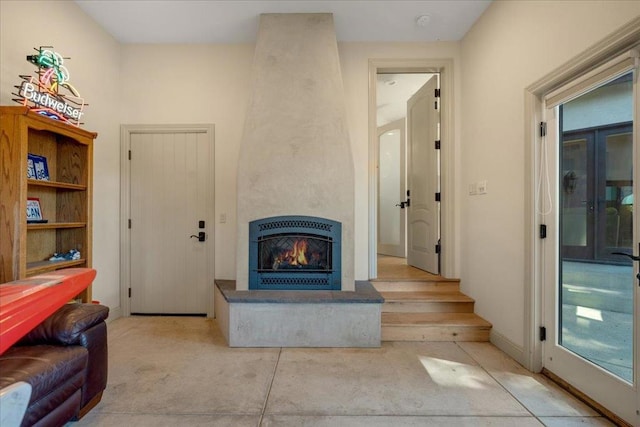 living room with a large fireplace and a healthy amount of sunlight