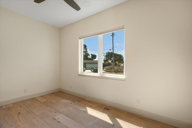 spare room featuring light hardwood / wood-style flooring and ceiling fan