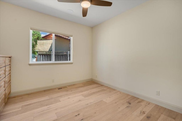 spare room featuring light wood-type flooring and ceiling fan