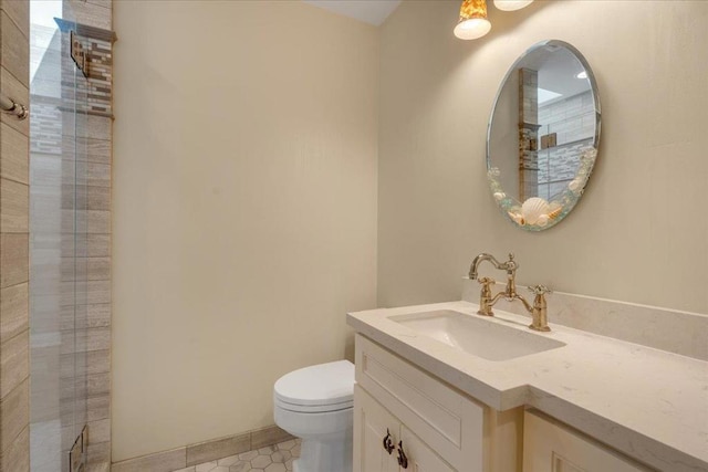 bathroom with vanity, toilet, tile patterned flooring, and an enclosed shower