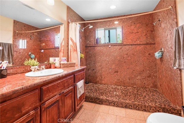 bathroom with tile patterned flooring, a shower with curtain, vanity, and toilet