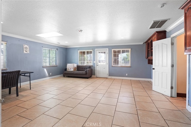 tiled living room featuring a textured ceiling, crown molding, and a wealth of natural light