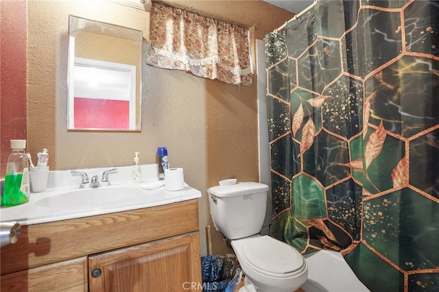 bathroom with vanity, toilet, and curtained shower