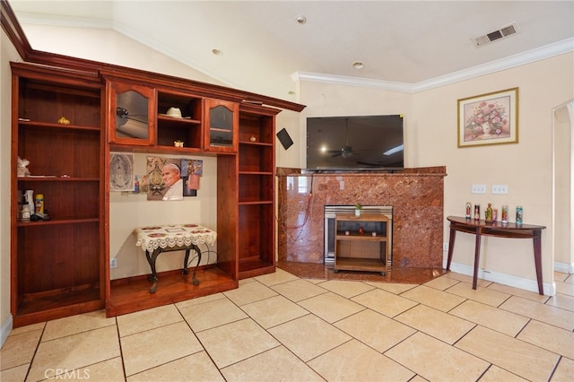 living room with vaulted ceiling and ornamental molding