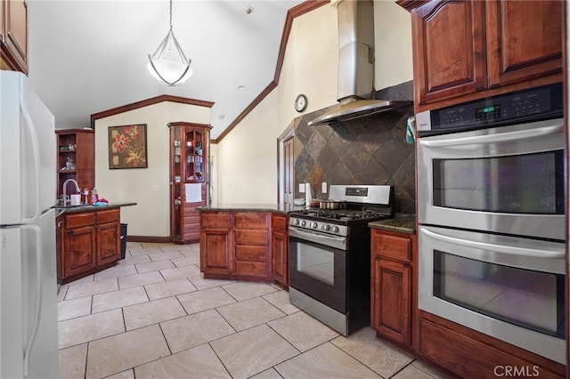 kitchen with decorative light fixtures, backsplash, ventilation hood, appliances with stainless steel finishes, and vaulted ceiling