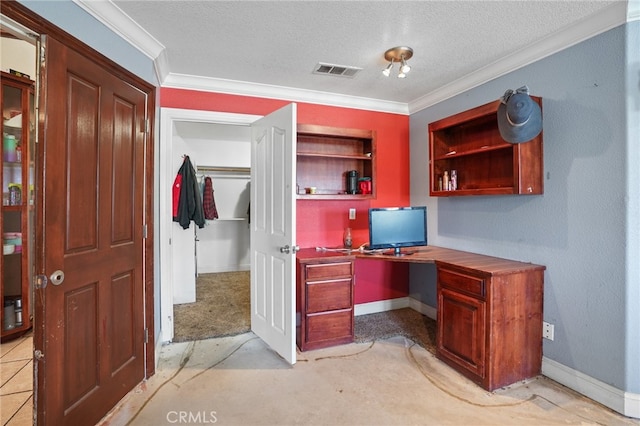 office space featuring light colored carpet, a textured ceiling, built in desk, and crown molding