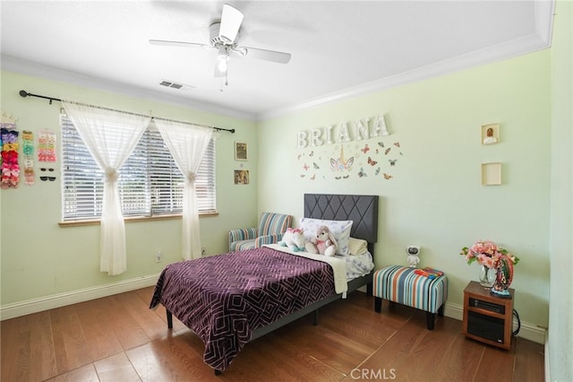 bedroom featuring crown molding, hardwood / wood-style floors, and ceiling fan