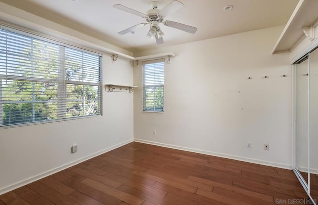 unfurnished room featuring ceiling fan and dark hardwood / wood-style floors