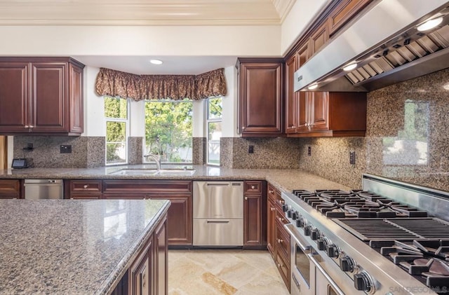 kitchen with appliances with stainless steel finishes, decorative backsplash, wall chimney exhaust hood, crown molding, and sink