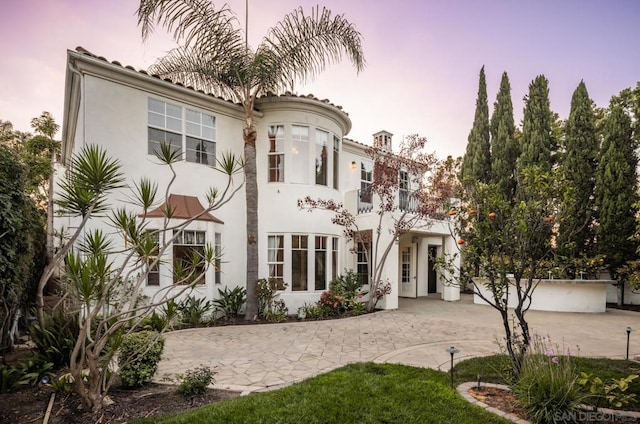 mediterranean / spanish-style house with a balcony and a patio