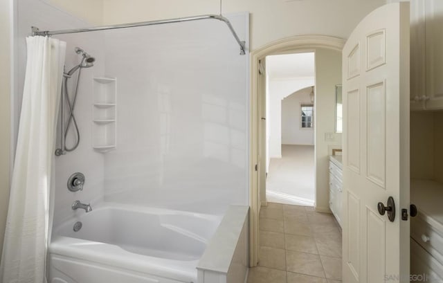 bathroom featuring shower / bath combo with shower curtain and tile patterned flooring