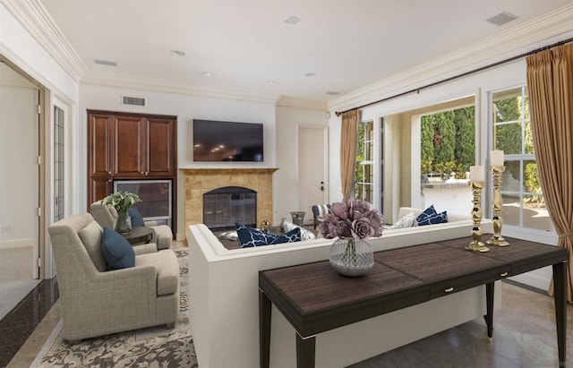 living room with ornamental molding and a high end fireplace