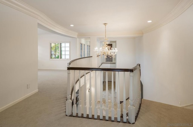 stairway featuring ornamental molding, a chandelier, and carpet