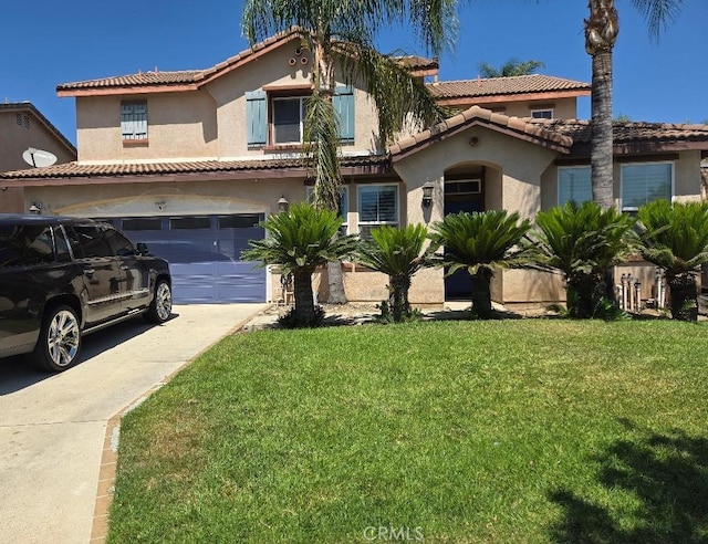 mediterranean / spanish-style house with a front yard and a garage