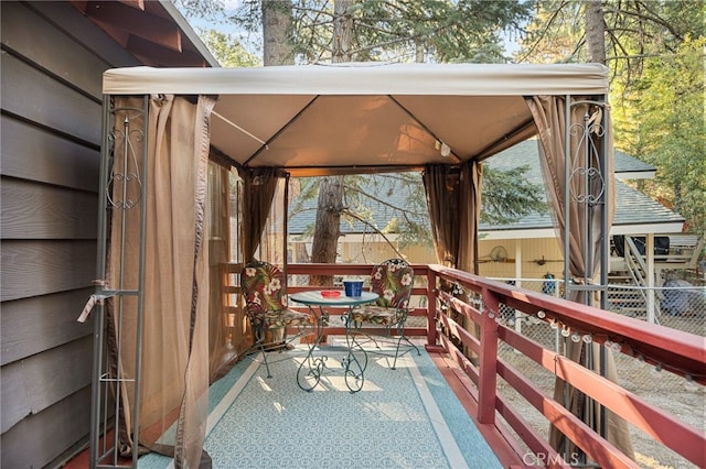 wooden terrace featuring a gazebo