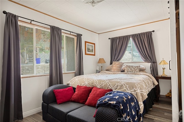 bedroom featuring ornamental molding and hardwood / wood-style flooring