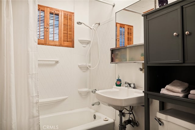 full bathroom featuring shower / bath combo, toilet, and sink