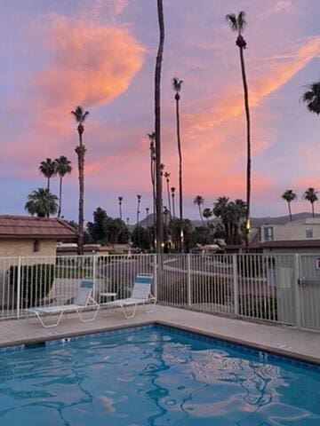 view of pool at dusk