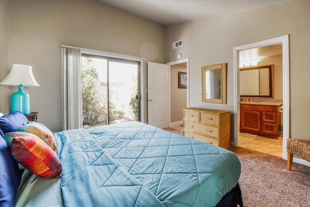 bedroom with access to outside, light carpet, and connected bathroom