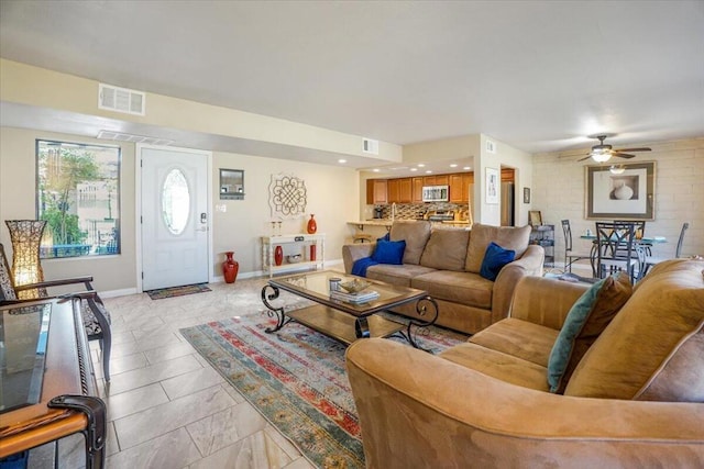 tiled living room featuring ceiling fan