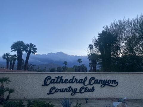 community sign with a mountain view