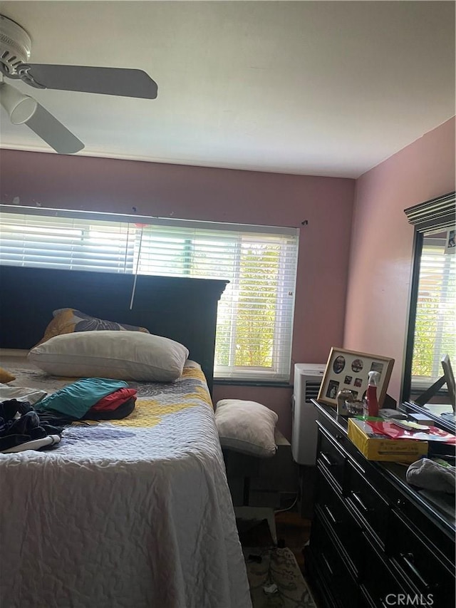 bedroom featuring multiple windows and ceiling fan