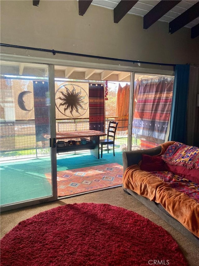 interior space featuring beamed ceiling and carpet flooring