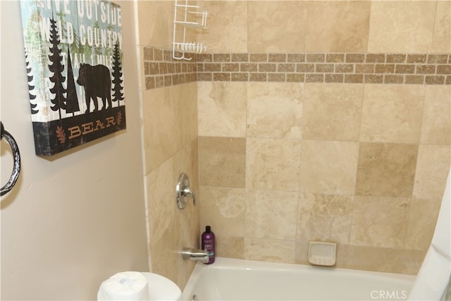 bathroom featuring shower / bath combo with shower curtain and toilet